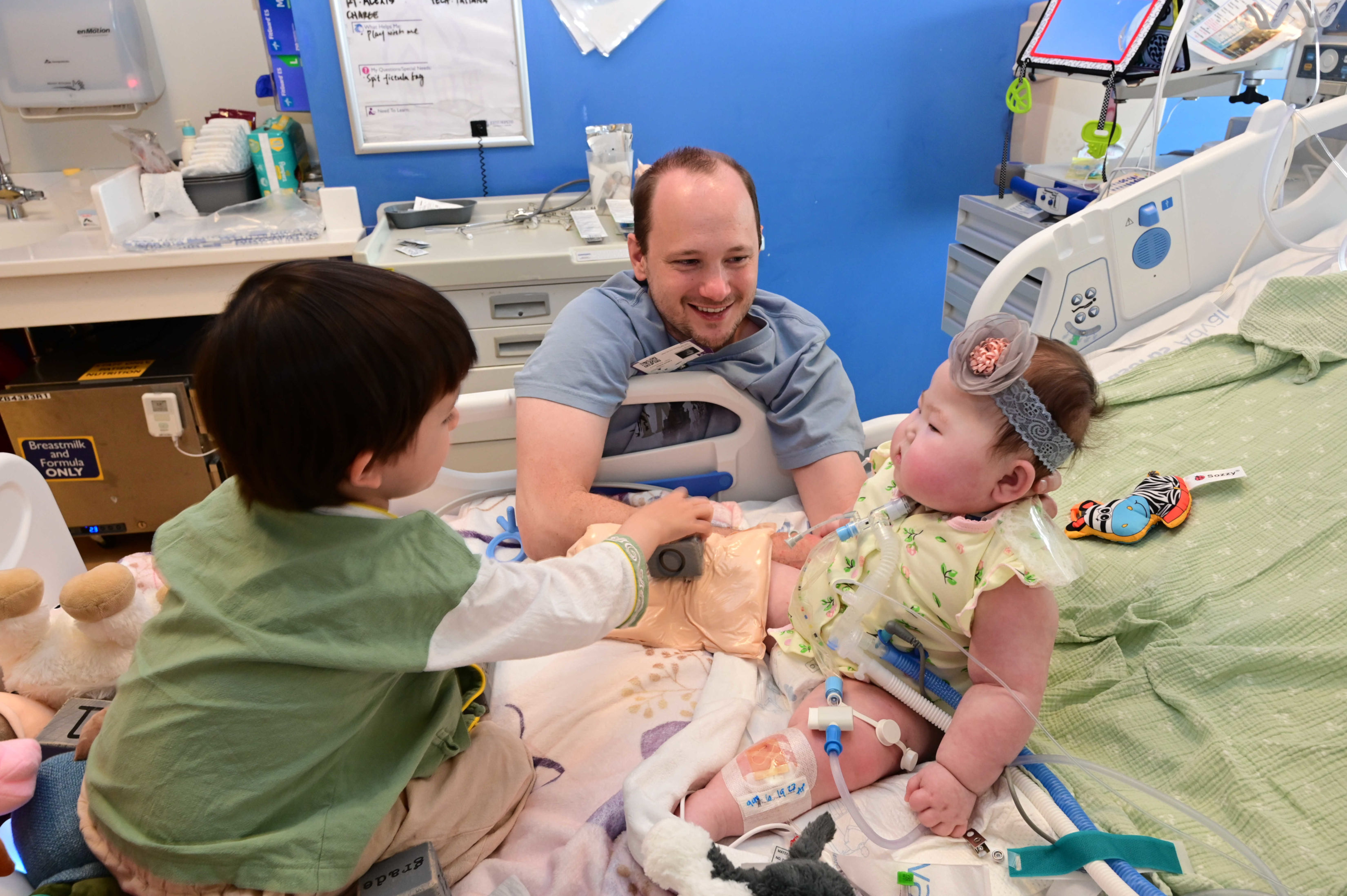 Image of Constance, her dada, and her brother on her bed