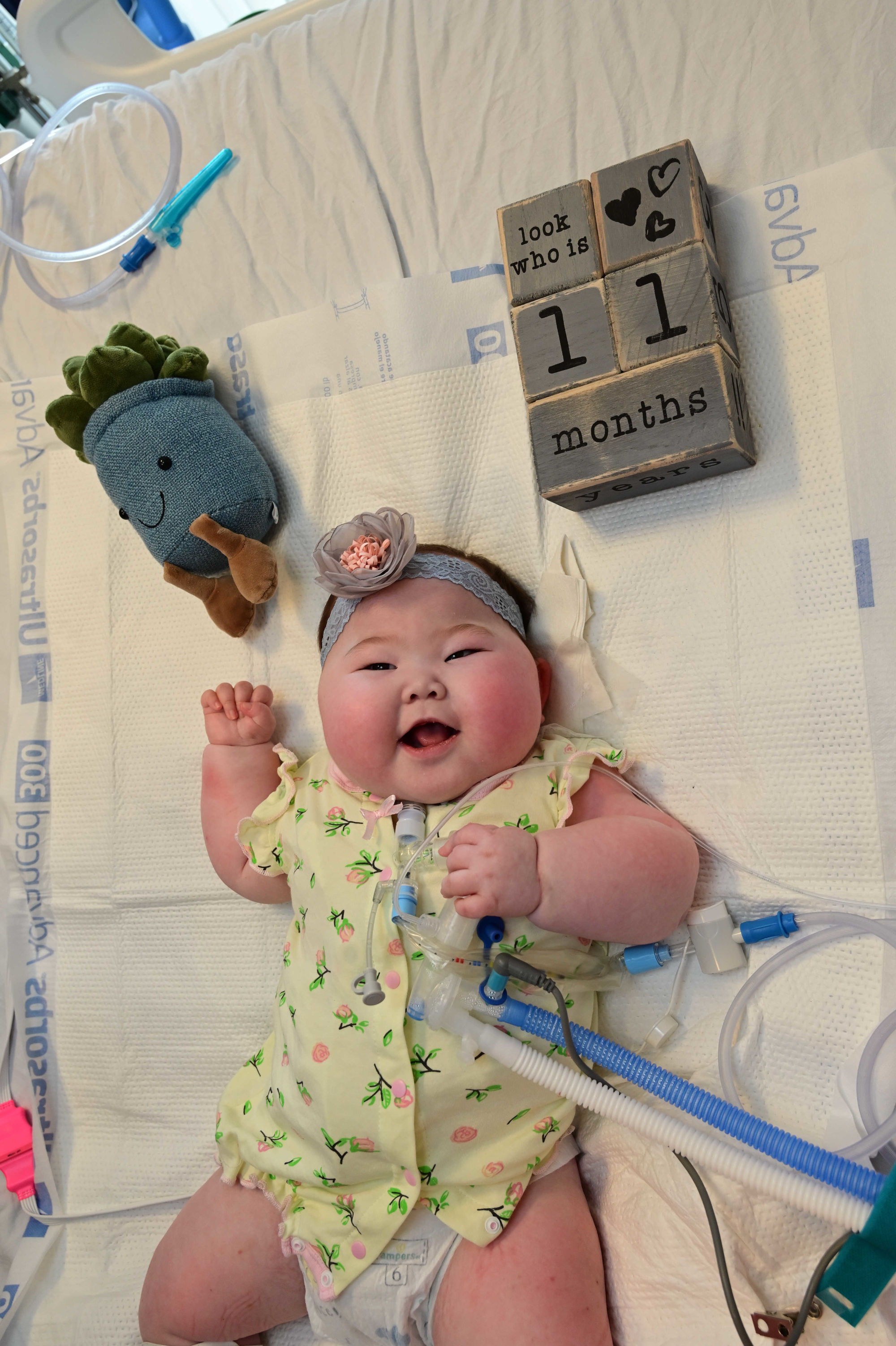 Image of Constance smiling with blocks written '11 months'