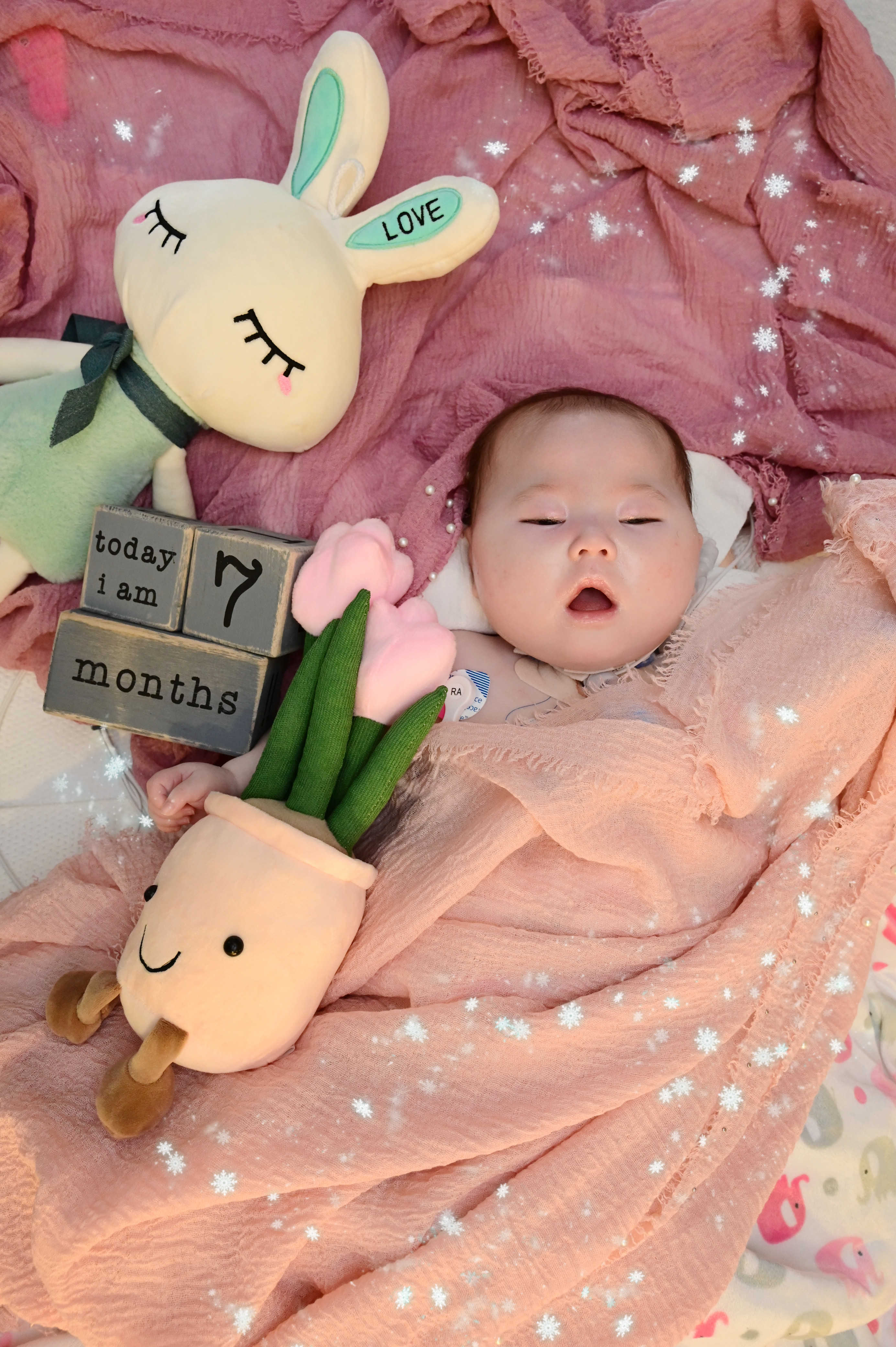 Image of Constance sleepy with blocks written 'today I am 7 months'